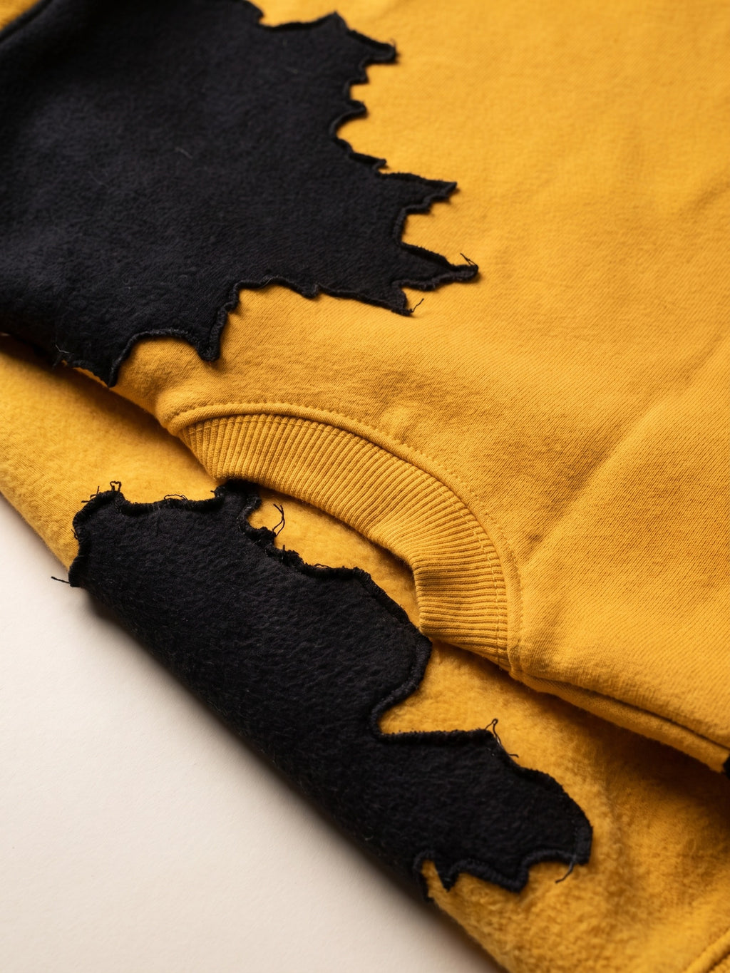 Spill Sweatshirt – Yellow – spill patch close-up