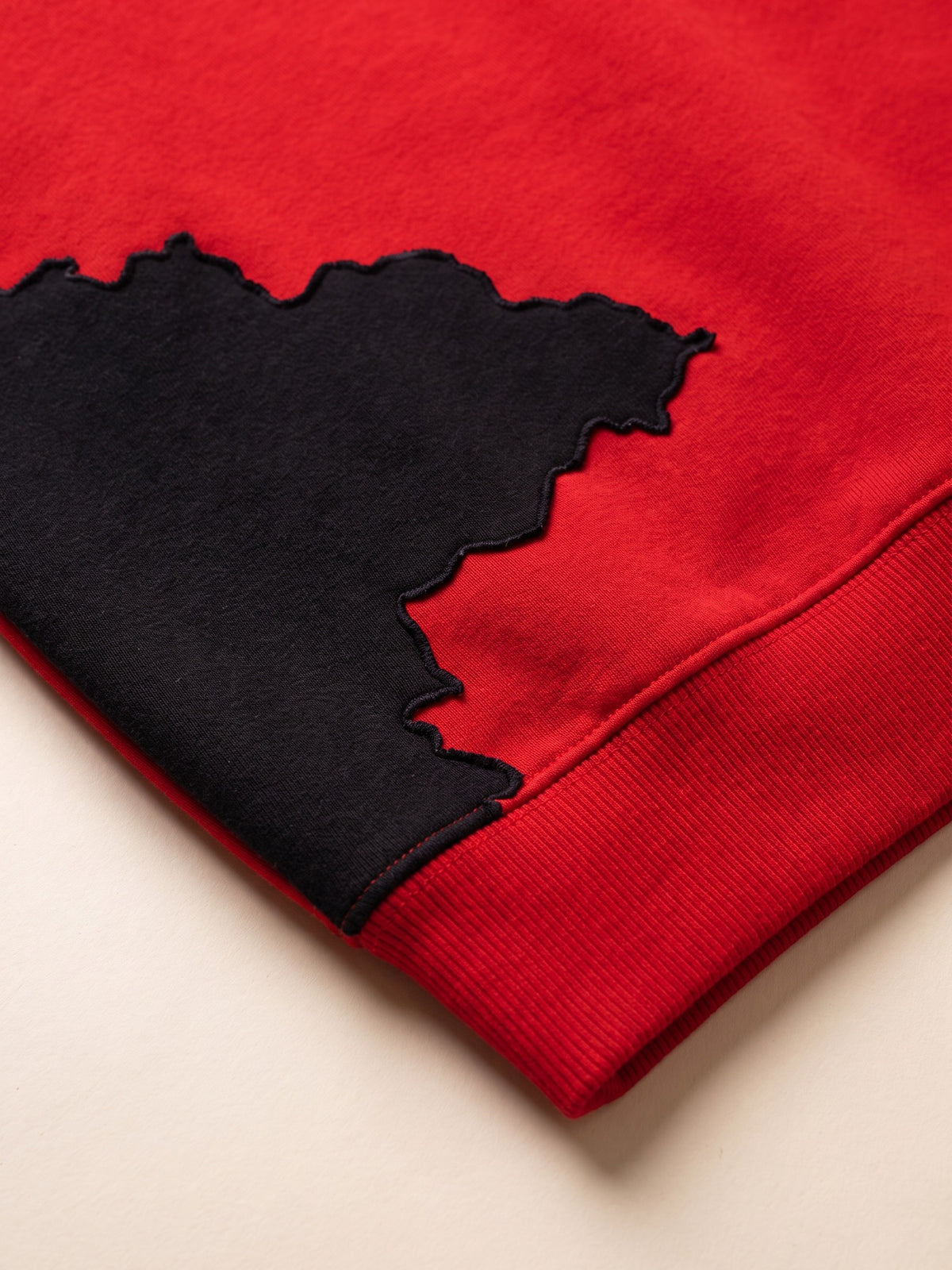 Spill Sweatshirt – Red – spill patch close-up